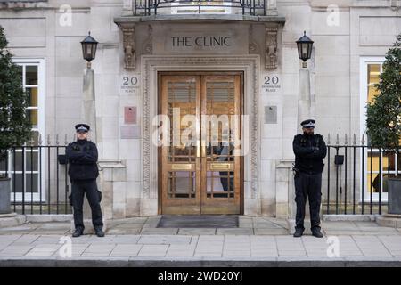 Police officers stand outside the London Clinic at Devonshire Place in Marylebone where the Princess of Wales is having abdominal surgery, England, UK Stock Photo