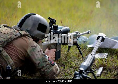 Sniper firing his rifle. Stock Photo