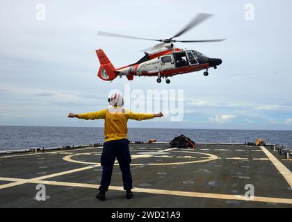 Crew members conduct flight operations with an HM-65 Dolphin helicopter. Stock Photo