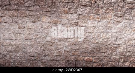 Old light stone wall background. Closeup front view of stone wall texture Stock Photo