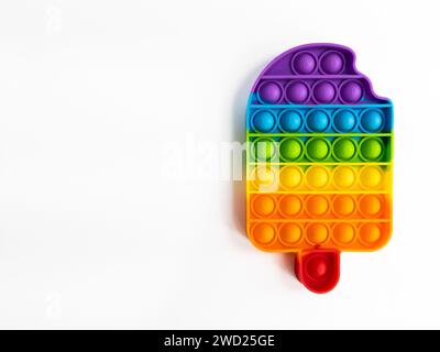 Colorful popit in the shape of ice cream on white background, with copy space. Stock Photo