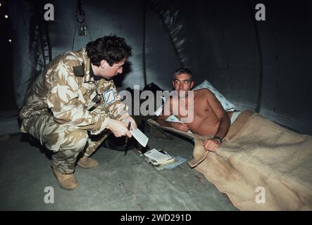 22nd January 1991 Squadron Leader Peter Battson is interviewed by Con Coughlin of the Sunday Telegraph in a hospital tent at the King Faisal Airbase. Stock Photo