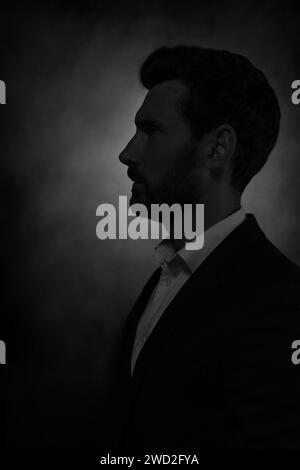 Silhouette of man in darkness. Portrait on black background Stock Photo