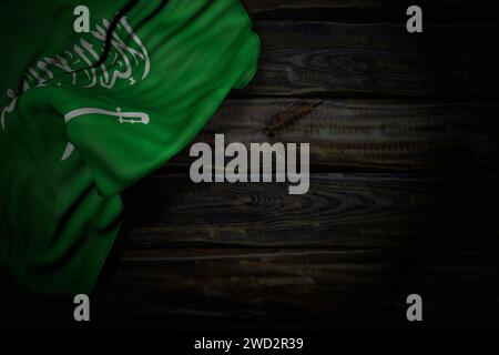 nice dark photo of Saudi Arabia flag with big folds on old wood with free space for content - any occasion flag 3d illustration Stock Photo
