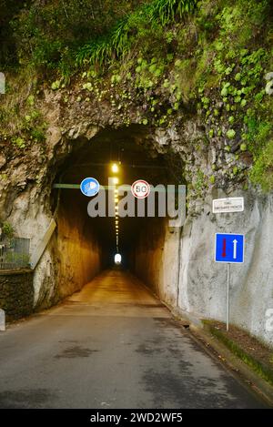 One-lane road passing through historic Engineer Duarte Pacheco Tunnel⁩⁦, completed in 1953, on Madeira Island, Portugal. Stock Photo