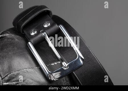 Part of a black crocodile leather belt. Expensive leather goods. Stock Photo