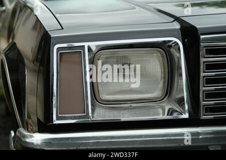 Headlight of an old Buick police patrol car, daytime close-up photo, without people, Buenos Aires, Argentina Stock Photo