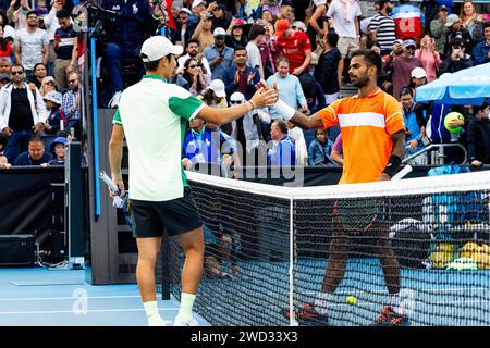 Melbourne, Australia. 18th Jan, 2024. Shang Juncheng (L) of China greets Sumit Nagal of India after their men's singles second round match at the Australian Open tennis tournament in Melbourne, Australia, Jan. 18, 2024. Credit: Chu Chen/Xinhua/Alamy Live News Stock Photo