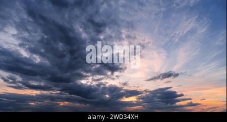 Dramatic sunset sky with dark clouds. Beautiful cloudscape at dusk. Stock Photo