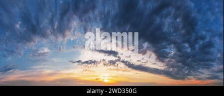 Dramatic sunset sky with clouds. Panorama of the evening sky. Stock Photo