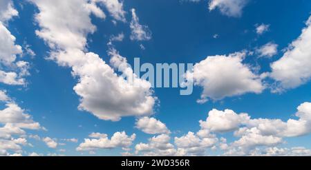 Natural background of white fluffy clouds on blue sky at daylight. Stock Photo