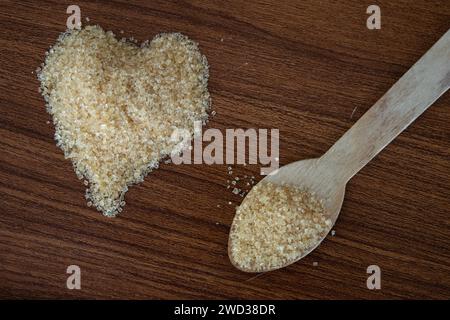 Brown Sugar in Heart Shape Stock Photo