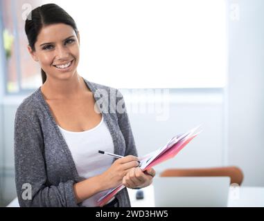 Portrait, editor and woman by contact sheet, confident and creative professional in career in office. Young designer, face or choosing image, studio Stock Photo