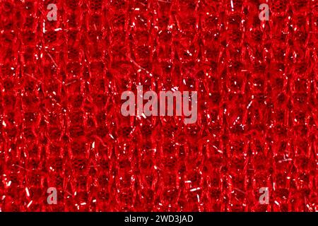 Red fabric with glitter made of polyester. Fabric industry, fabric for making warm clothes Stock Photo