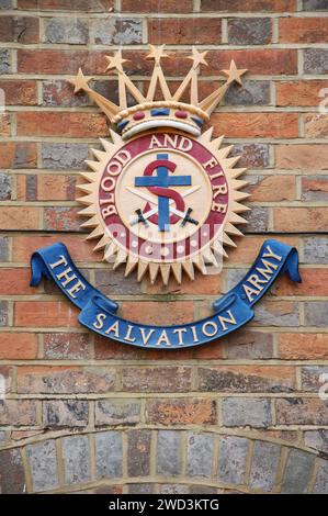 The crest of the Salvation Army, a Protestant Christian movement, with the motto “Blood and Fire”, mounted on the wall of the Wimborne Church. Dorset. Stock Photo