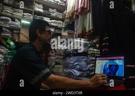 Indonesia 18th Jan 2024 A Fabric Trader Was Spotted Managing An E   Indonesia 18th Jan 2024 A Fabric Trader Was Spotted Managing An E Commerce Website At Mutiara Deli A Muslim Fashion Shop In The Pasar Ikan Clothes Trading Area Of Medan City North Sumatra Province Indonesia On January 18 2024 Using E Commerce Website Services Has Become Increasingly Popular Among Business People As It Helps Them Overcome Traffic Congestion And Reduces Marketing Costs In Sustainable Commerce Photo By Sutanta Adityaabacapresscom Credit Abaca Pressalamy Live News 2wd3txr 