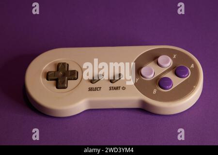 Nintendo type video game contollers on a mouve background, studio photography Stock Photo