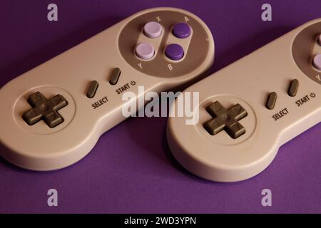 Nintendo type video game contollers on a mouve background, studio photography Stock Photo