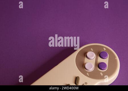 Nintendo type video game contollers on a mouve background, studio photography Stock Photo