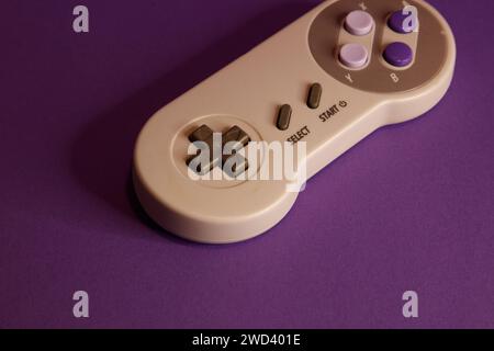 Nintendo type video game contollers on a mouve background, studio photography Stock Photo