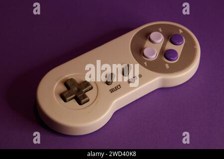 Nintendo type video game contollers on a mouve background, studio photography Stock Photo