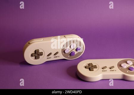 Nintendo type video game contollers on a mouve background, studio photography Stock Photo