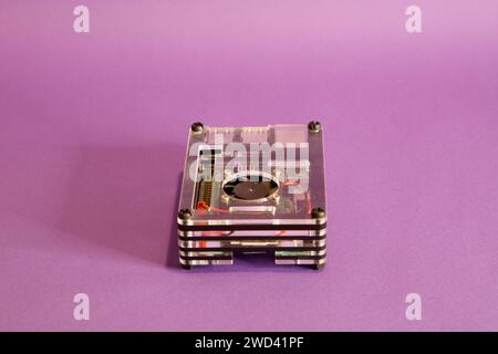 a Raspberry Pie 3 computer, on a mouve background, studio photography Stock Photo