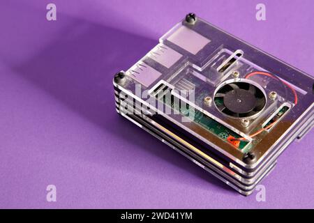 a Raspberry Pie 3 computer, on a mouve background, studio photography Stock Photo