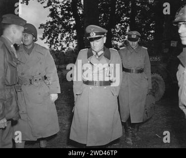 NEAR CHERBOURG, FRANCE -  circa 01 July 1944 - Wermacht General Robert Sattler and an aide-du-camp depart from a conference after surrendering his com Stock Photo