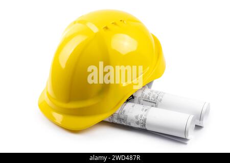 Yellow safety hard hat with engineering drawings on white background Stock Photo
