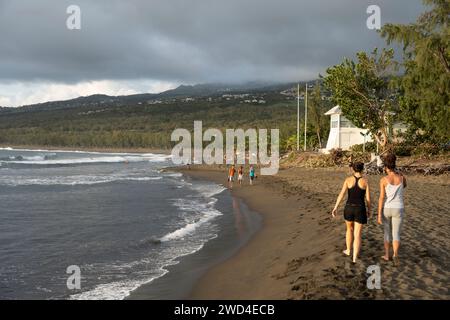 Tourists enjoying the Etang-Salé beach on Réunion Island. The island, located in the Indian Ocean, is a popular travel destination for tourism. Stock Photo