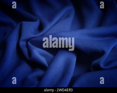A crumpled dark blue fabric background. Close up. Stock Photo
