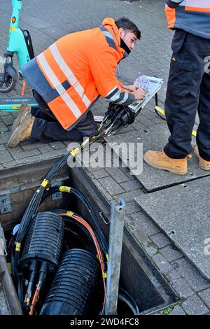 Instillation of fibre optic cables in junction box in underground duck work by engineer, UK Stock Photo