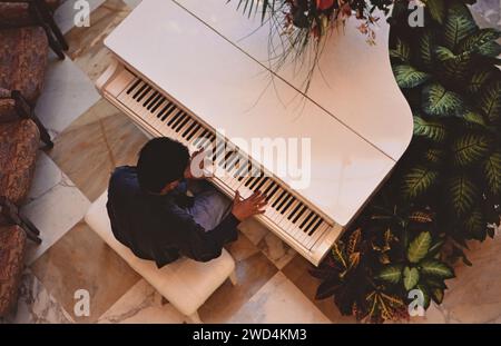 View from above of a pianist playing on a Crown Cruise Lines ship ca. 1993. Please credit photographer Joan Iaconetti. Stock Photo