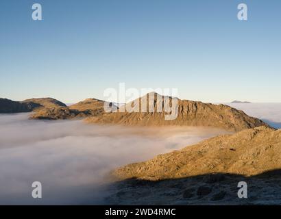 Bowfell, Esk Pike and Great End seen from Crinkle Crags during a cloud inversion in the Lake District National Park, Cumbria, England Stock Photo