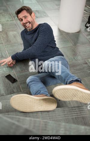 mature man lying on staircase after slip and fall accident Stock Photo