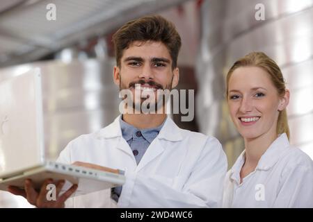 couple of young workers using a laptop Stock Photo
