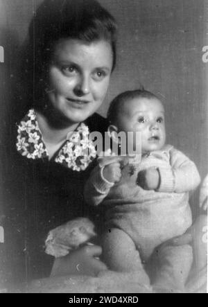 An antique photo shows portrait of a young Caucasian woman with her little daughter. Germany. Date unknown, circa 1930s Stock Photo