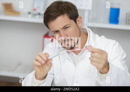 man scientist using auto-pipette with flask in medical science laboratory Stock Photo