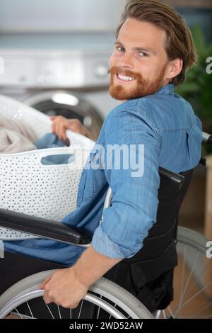 capable disabled man doing laundry Stock Photo