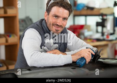 male mechanic using an angle grinder Stock Photo