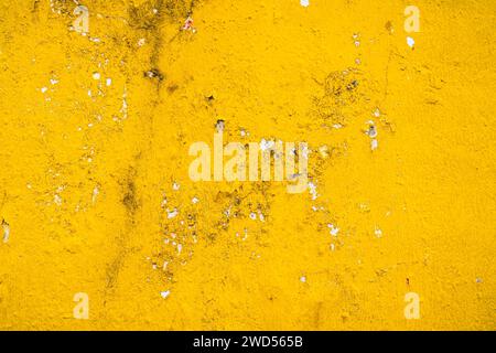 Grunge old concrete wall painted in bright yellow with cracks. Abstract texture, background, full frame Stock Photo
