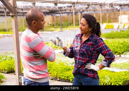 Two latino garden workers discussing working process Stock Photo