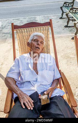 Merida Mexico,centro historico central historic district,senior man napping sleeping siesta,rocking chair,man men male,adult,resident residents,senior Stock Photo