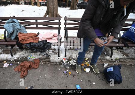 New York, USA. 18th Jan, 2024. Asylum seeking migrants, mostly from West Africa, gather in Tompkins Square Park outside St. Brigid reticketing center on Manhattan's Lower East Side, New York, NY, January 18, 2024. Migrants wait for a new shelter assignment after a 30 day limit was recently imposed, forcing them to re-apply and wait; it is estimated that approximately 3000 migrants arrive each week in New York City. (Photo by Anthony Behar/Sipa USA) Credit: Sipa USA/Alamy Live News Stock Photo