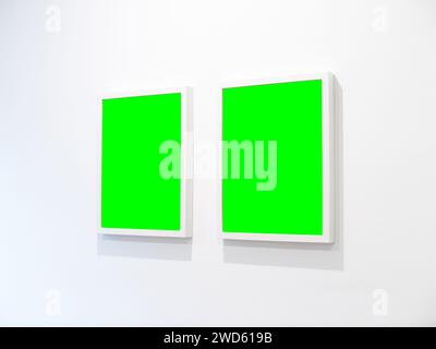 Empty picture frames on a white wall template. Mockup for two photos in a domestic space. Interior decoration at home in a modern environment. Stock Photo