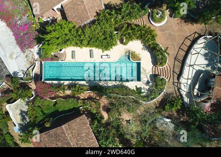 Long swimming pool in middle of tropical resort aerial drone view Stock Photo
