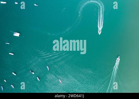 Small boats moving in blue sea water aerial above top drone view Stock Photo