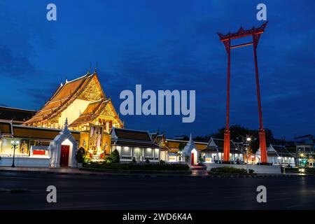 Wat Suthat and Giant swing in Bangkok, Thailand. Early morning just before dawn; deep blue sky overhead. Stock Photo