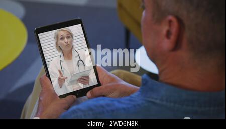 Diverse senior man and female doctor having video call on tablet Stock Photo